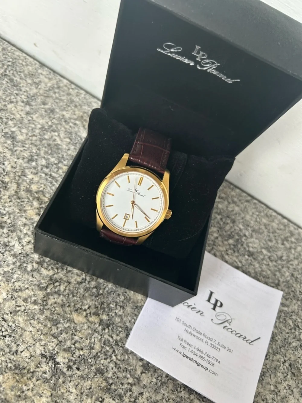 Lucien Piccard Gold Tone Case with Brown Strap and White Dial Accents